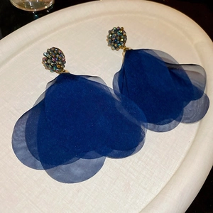 Detail of blue mesh flower earrings with crystal center and golden base for women