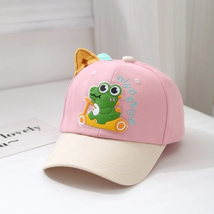 Close-up of kids dinosaur baseball cap with 3D ears and cartoon PVC appliqué detail