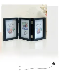 Three-fold black matte photo frame with silver metal hinges and folding design