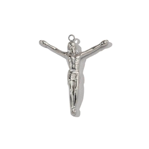 Detailed view of polished stainless steel Jesus cross pendant on white background