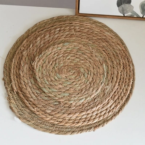 Macro detail of natural seagrass woven coaster with spiral pattern and reinforced edges