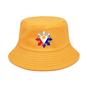 Detail of yellow cotton bucket hat featuring a Philippine themed graphic and reinforced brim