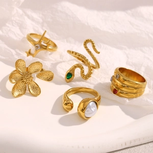 Detail view of five 18K gold plated rings set with pearls and gemstone accents