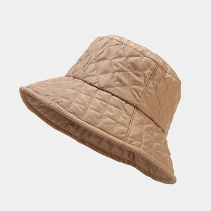 Detail of khaki quilted bucket hat showing diamond stitching and warm padded texture