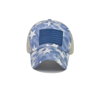 Detail of blue tie-dye cotton trucker hat with star pattern and USA flag patch