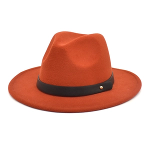 Close-up of burnt orange wool fedora featuring black faux leather belt and gold stud detail
