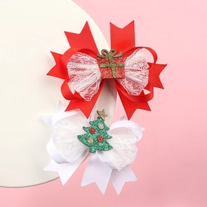 Detail of Christmas bow hair clips with glitter gift box and tree resin charms