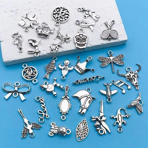 Collection of vintage silver alloy charms featuring animals, crowns, and bows for DIY jewelry