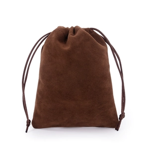 Detailed texture of brown velvet jewelry pouch with matching drawstring closure