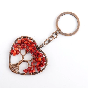 Detailed view of handmade heart-shaped Tree of Life keychain with red natural crystal stones