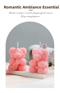 Detailed view of pink rose bear scented candles with delicate floral textures and white wicks