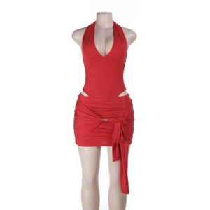 Detail of red halter neck top and ruched mini skirt set with metallic hardware