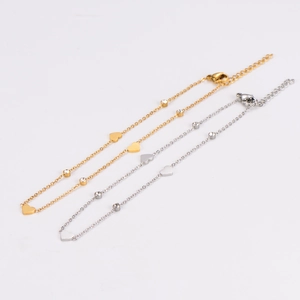 Minimalist heart charm anklet in gold and silver finish with transparent gemstones