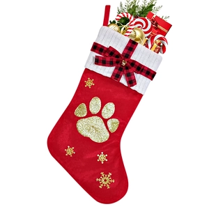 Detail of red Christmas stocking featuring gold glitter paw print and holiday gift fillers