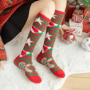 Red and green striped Christmas fluffy socks with gingerbread man pattern holiday decor