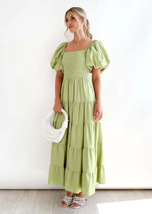 Detail of puff sleeves and elastic pleated square neckline on grass green dress