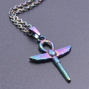 Macro view of rainbow dragonfly Ankh pendant with intricate etched metal textures