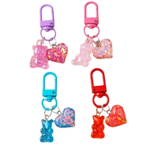 Gummy bear heart keychains in purple, pink, blue, and red with sparkly heart charms