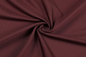 Close-up of premium burgundy ribbed fabric showing fine texture and glossy sheen