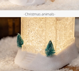 Close-up of LED glowing Christmas house ornament with ice crystal texture and mini trees