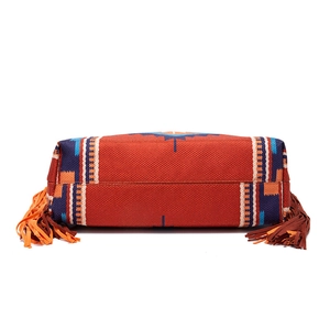 Flat bottom view showing sturdy stitching of a woven bohemian shoulder bag with fringe