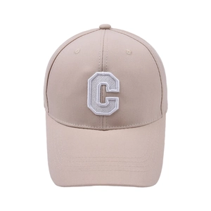Detail view of the fine white 3D embroidery of the letter C on a beige baseball cap