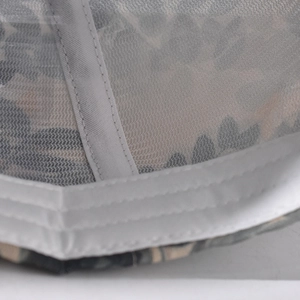 Macro shot of breathable mesh baseball cap with blue floral pattern and white stitching