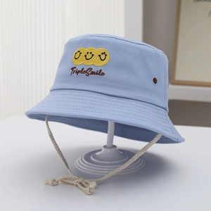 Detail of light blue cotton bucket hat with yellow triple smile embroidery and chin strap