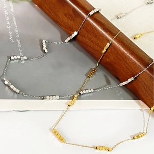 Minimalist titanium steel necklace with small square beads in 18K gold and silver finishes
