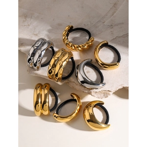 Detail of assorted 18k gold and silver metal hair ties with various textured finishes