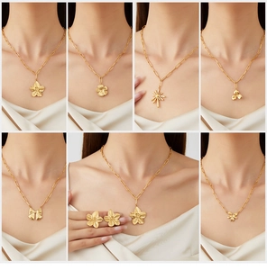 Close-up of vintage gold stainless steel necklaces with flower and bow pendants