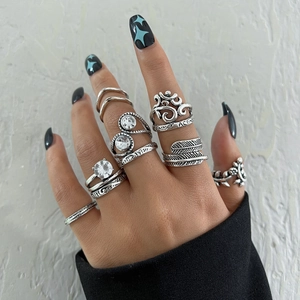 Close-up of gothic silver ring set featuring Ace text and bohemian gemstone details