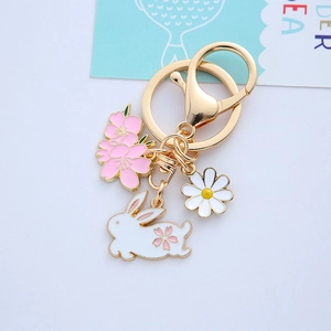 Cute metal rabbit keychain with cherry blossom and daisy enamel charms in gold finish