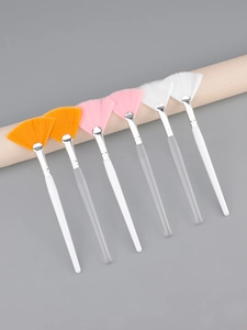 Detailed view of six professional fan-shaped facial masks brushes with colorful bristles