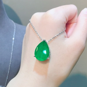 Elegant pear-cut emerald green gemstone pendant with a minimalist silver chain necklace