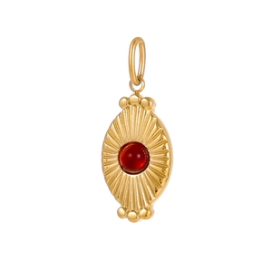 Macro view of a gold stainless steel pendant with a round red stone inlay and radial texture