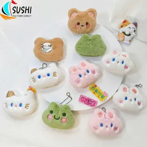 Close-up of plush animal brooches with metal pin backings and bead chains for bags