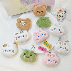 Close-up of plush animal brooches with metal pin backings and bead chains for bags