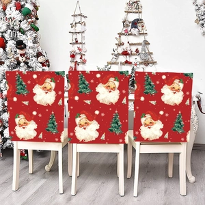 Detail of red Christmas chair covers with Santa Claus and tree patterns for festive dining