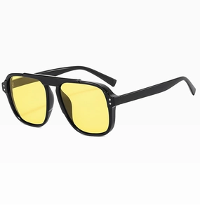 Detail of pilot sunglasses with yellow lenses, double bridge, and silver rivet accents