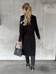 Back view of long black double-breasted wool coat with sleek rear vent design