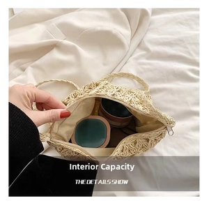Detail view of woven straw bag interior with white zipper and compact storage space