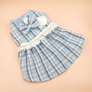 Detail of tweed pet dress featuring pearl chain and white camellia flower decoration