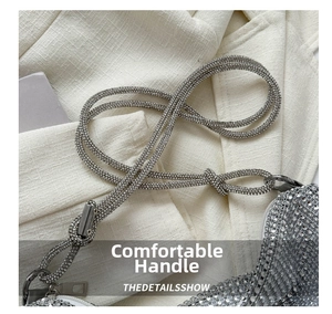Detail of silver rhinestone tote bag with knotted rope handle and metal hardware