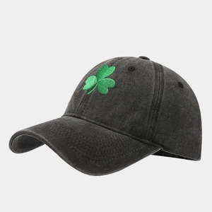 Detailed close-up of green shamrock embroidery on a vintage washed black baseball cap