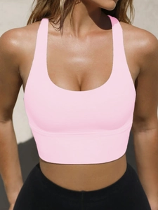 Close-up of pink high-elastic yoga tank top featuring a U-shaped neckline and soft fabric