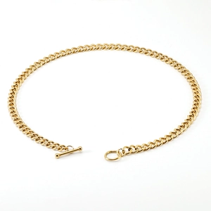 Detailed macro view of 18K gold stainless steel Cuban chain with a polished OT toggle clasp