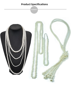Detail view of long French style baroque pearl necklace with sparkling rhinestone tassels