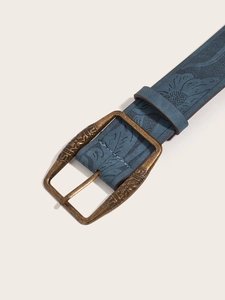 Macro view of vintage Y2K blue embossed leather belt with bronze floral buckle detail