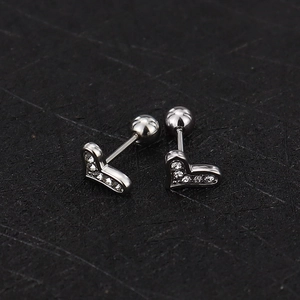 Detail of silver heart cartilage stud earrings with zircons and secure screw back balls
